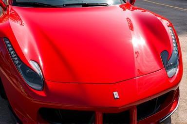 Glossy red sports car with PPF showing mirror-like finish